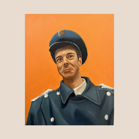 expressive portrait of man in blue captain uniform looking at the camera