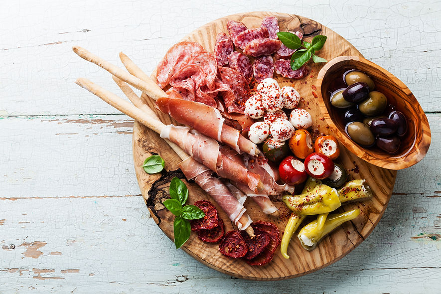 Antipasto Platter Cold meat plate with grissini bread sticks on wooden background.jpg
