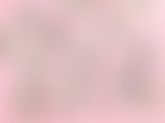 Rolled and stacked US dollar bills secured with rubber bands on a pink background, featuring various denominations including 100 and 5.