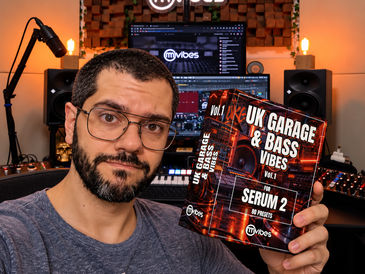 Rafael Manga holding the UK Garage & Bass Vibes Serum 2 preset pack in his music studio