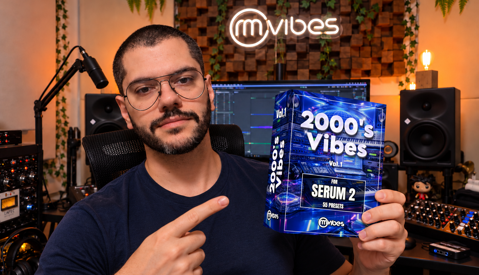 Rafael Manga holding the 2000's Vibes Serum 2 preset pack in his music studio