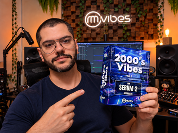 Rafael Manga holding the 2000's Vibes Serum 2 preset pack in his music studio