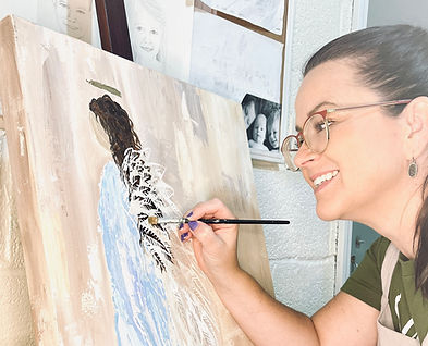 Artist Sara Sills painting a heavy textured acrylic painting in memory of a loved one