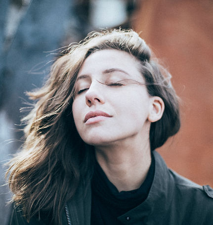 Woman with closed eyes, embracing self-awareness and emotional well-being.