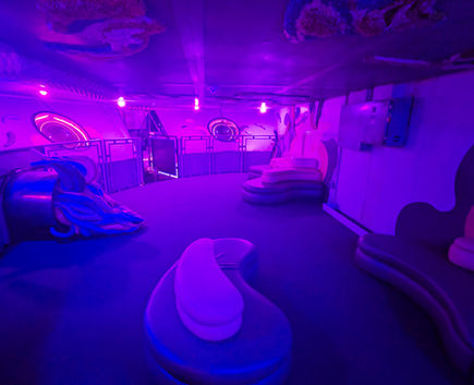 The purple lit DeLuLu Lounge in Omega Mart, Meow Wolf Las Vegas.