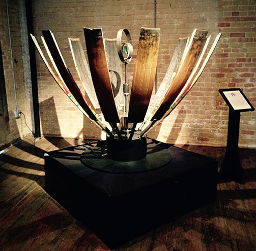 A decorated tequila barrel spinning open like an aloe plant