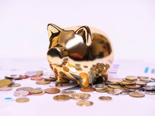 Golden piggy bank resting on financial documents, representing superannuation savings and the Division 296 super tax