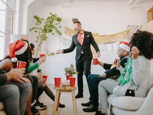 Colleagues at an office Christmas party raising cups of drinks, the kind of night the FBT rules were written for.