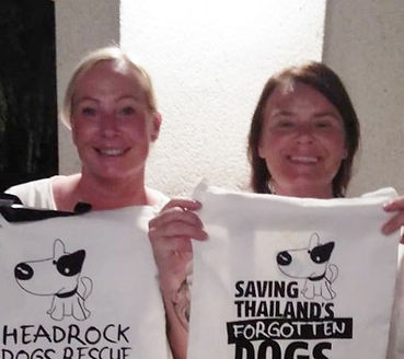 2 girls holding up headrock T-shirts