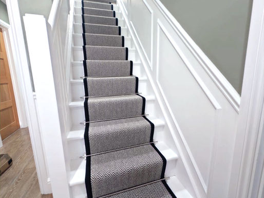 Herringbone Stair Runner with Customer Black Tape and a berber landing carpet. 