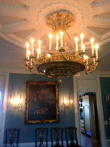 Large antique chandelier in ornate dining room