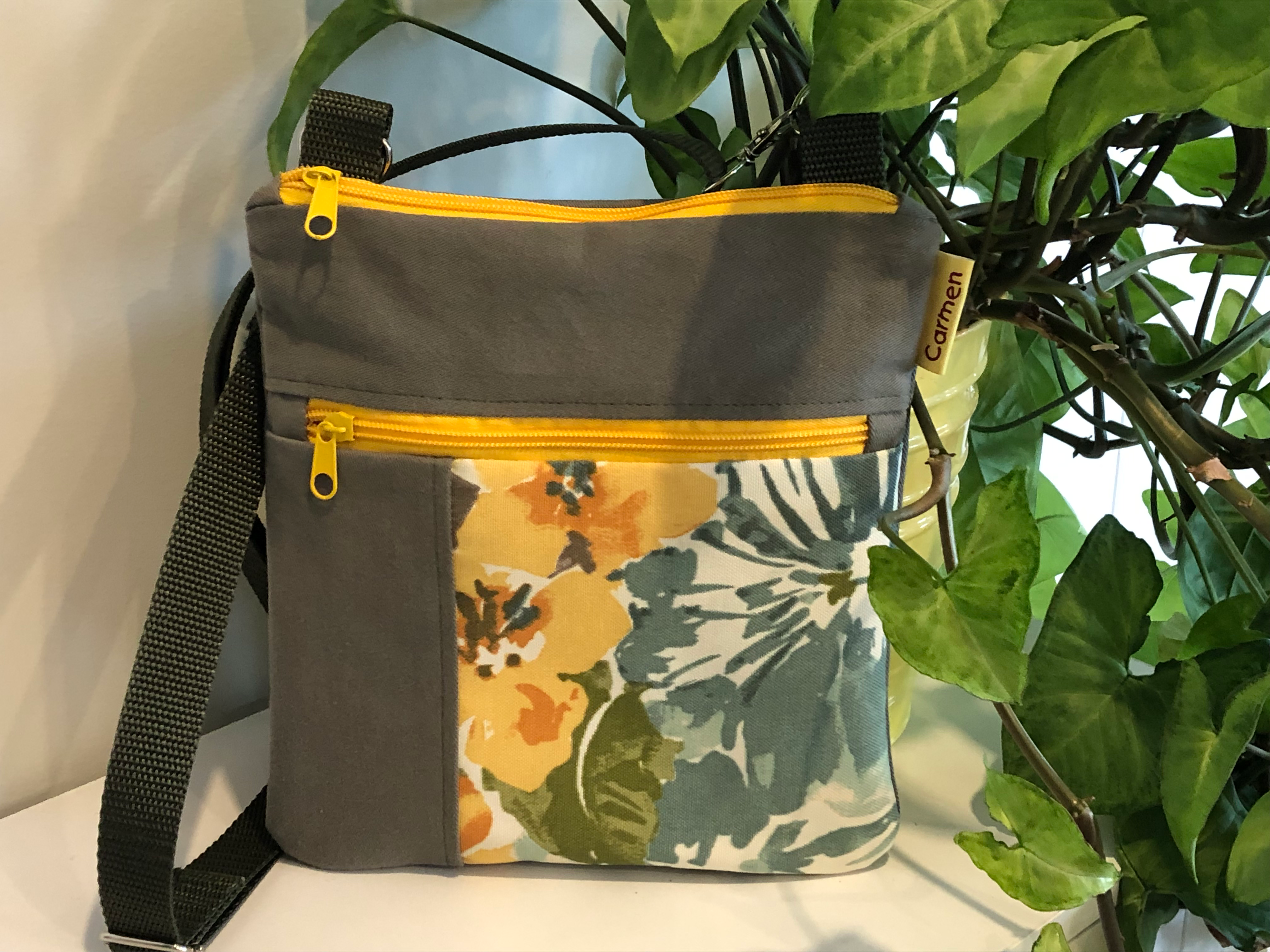 Sac pochette de toile verte avec des fleurs oranges et jaunes