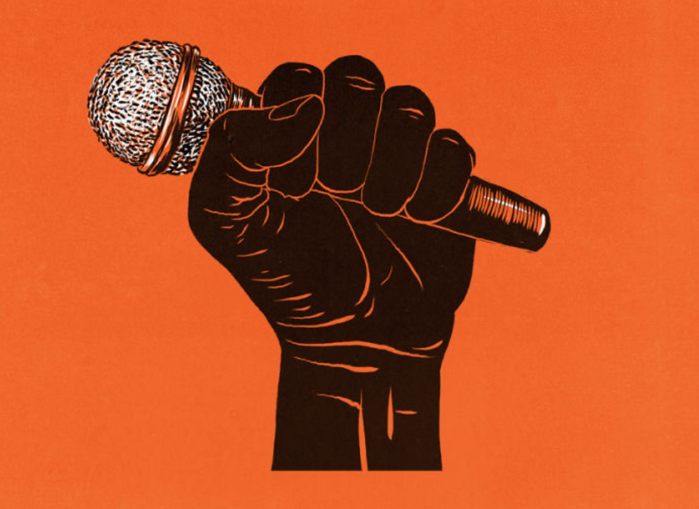 Black power fist holding a microphone