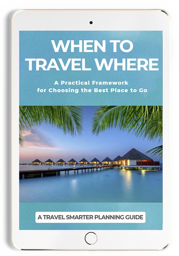 Tablet displaying travel guide cover titled When to Travel Where, with tropical overwater resort at sunset and palm fronds.