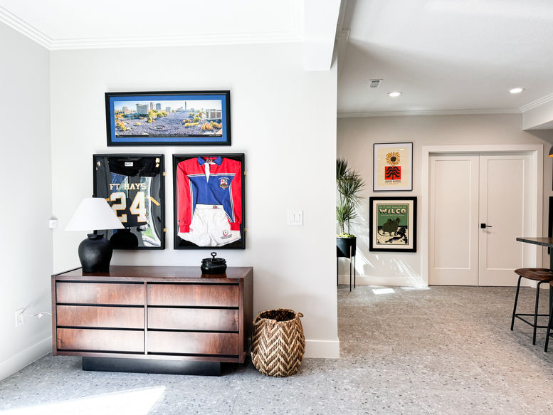 Interior room with sports memorabilia on the wall and a dresser
