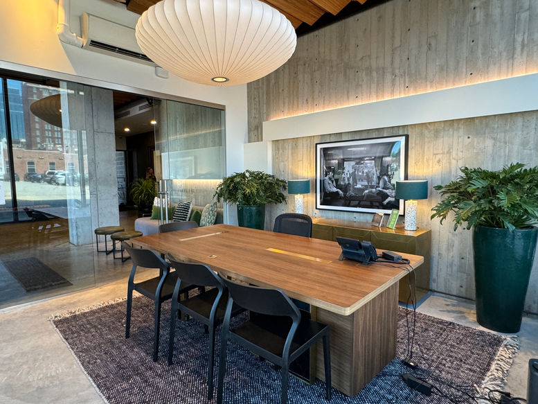 Modern REVERB Leasing Office & Lobby with a large wooden table and art