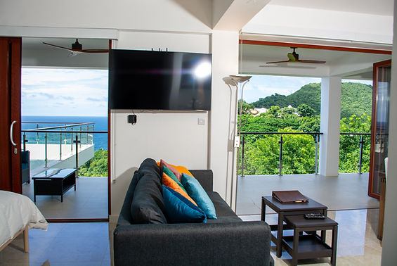 Enjoy stunning Caribbean Sea views from Suite Zinfandel, a cozy studio with a wraparound balcony and modern amenities.