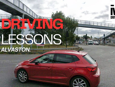 Learner driver receiving calm instruction on a quiet Derby street