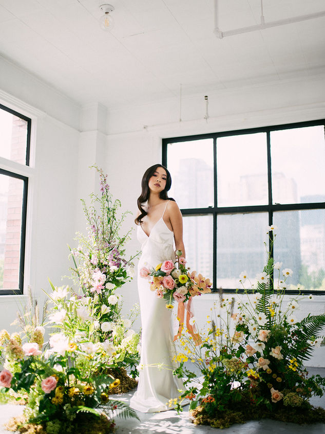 Ella is a spaghetti strap bias cut silk satin crepe dress with low back, simply adorned with strings of pearls. It has V shape seams at back for longer train look.