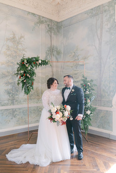 Laura & Joe on their elopement day at the Curtis Arboretum smiling in front of their elopement ceremony space