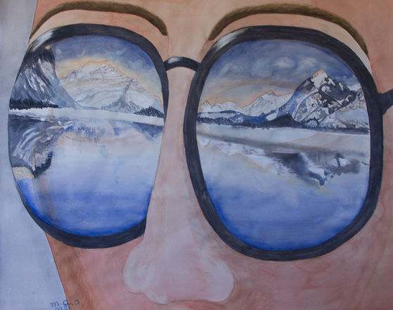 A majestic landscape from the rocky mountains reflecting in sunglasses