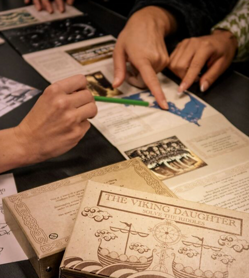 Some people playing boardgames : The viking daughter solve the riddles