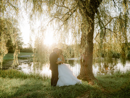 Bride and Groom sunset photos under the willow tree at the Dunham Homestead after a wedding ceremony at the Heritage Barn