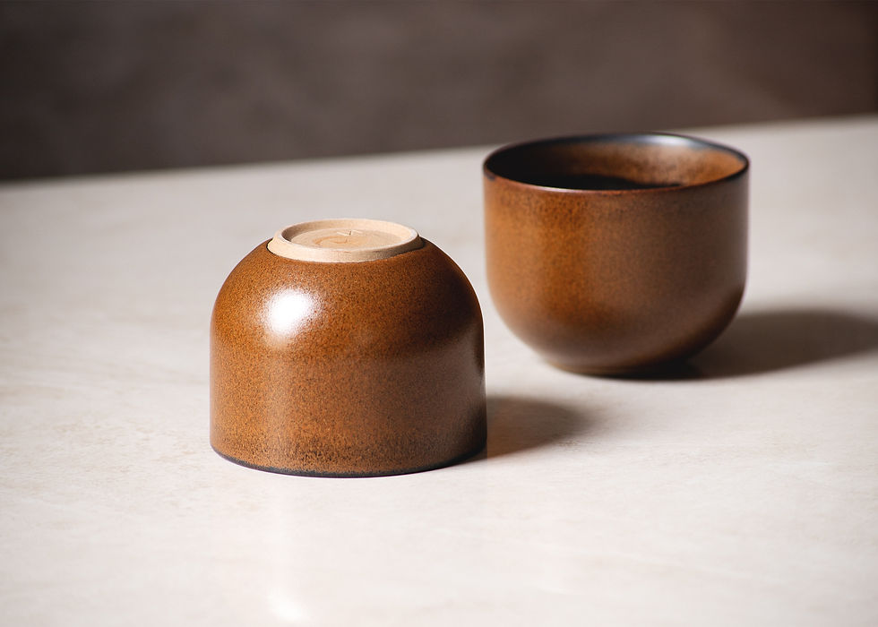 Thumbnail: Front view of a pair of minimalist, brown, rustic ceramic cups on a white marble surface. One is upside down.