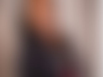 Tuesday Irby dressed in black with a shirt that says prop fairy, wearing mala beads and smiling at the camera