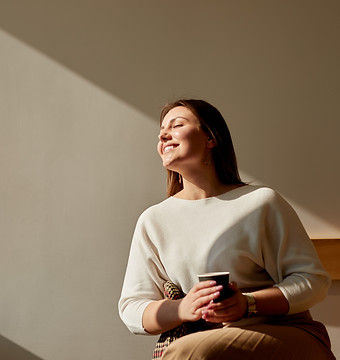 happy-woman-enjoying-morning-coffee-cafe.jpg
