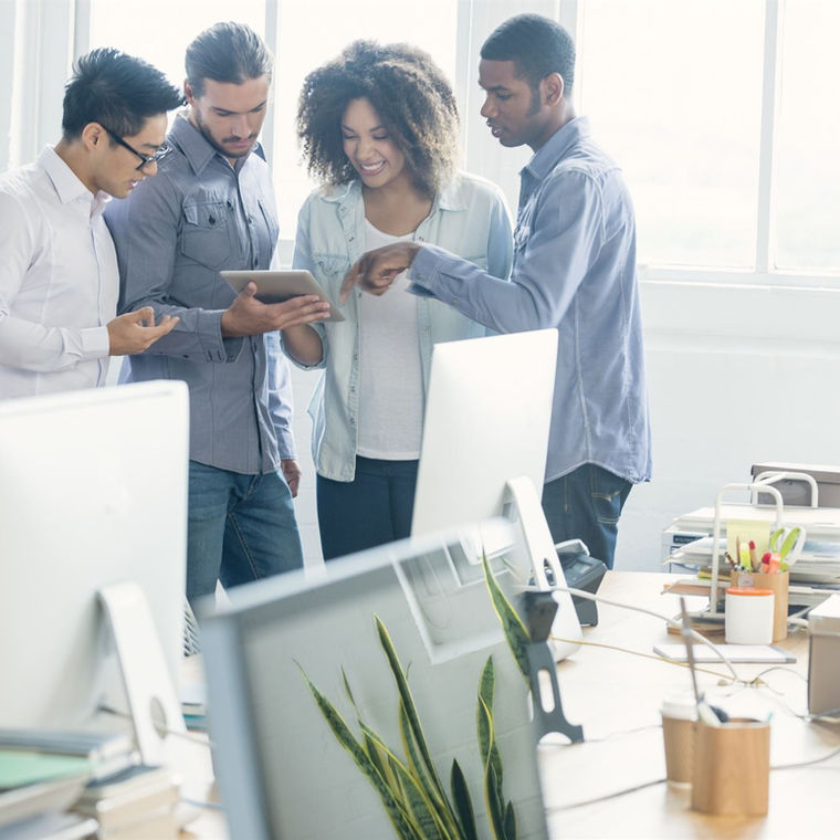 A team looking at a tablet together