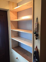 new shaving unit in hallway with cupboard door at the bottom for shoe storage