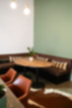 Cozy corner with a wooden table and stylish seating in a private office at Flockd.