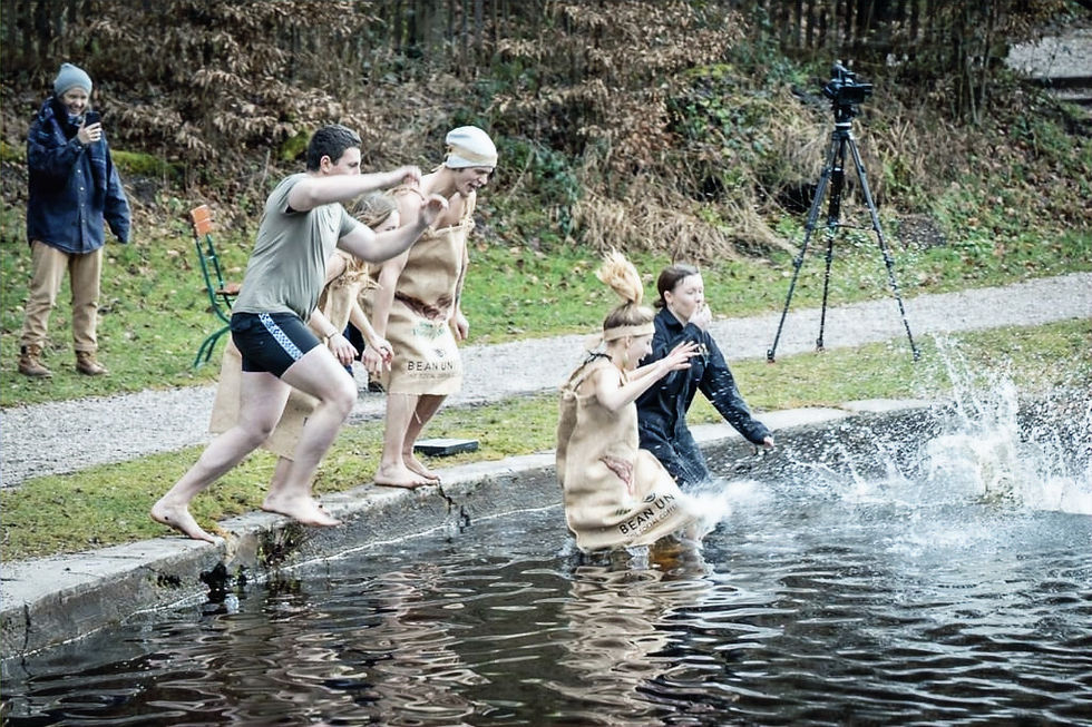The Bean United team jumping into a lake.