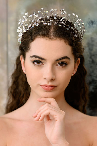 Introducing our enchanting crystal headpiece, a magical adornment that embodies glass-like transparency and an unparalleled sparkle, thanks to the dazzling Swarovski crystals and masterful structure. Crafted to be lightweight and flexible, this headpiece offers both elegance and comfort for brides. Bespoke color options available upon request. Add a touch of sparkle and sophistication to your bridal ensemble with this exquisite accessory.