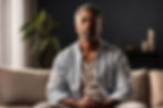 Man meditating on a sofa in a cozy room, eyes closed, wearing a light blue shirt. Candles and plants in the background create a calm mood.