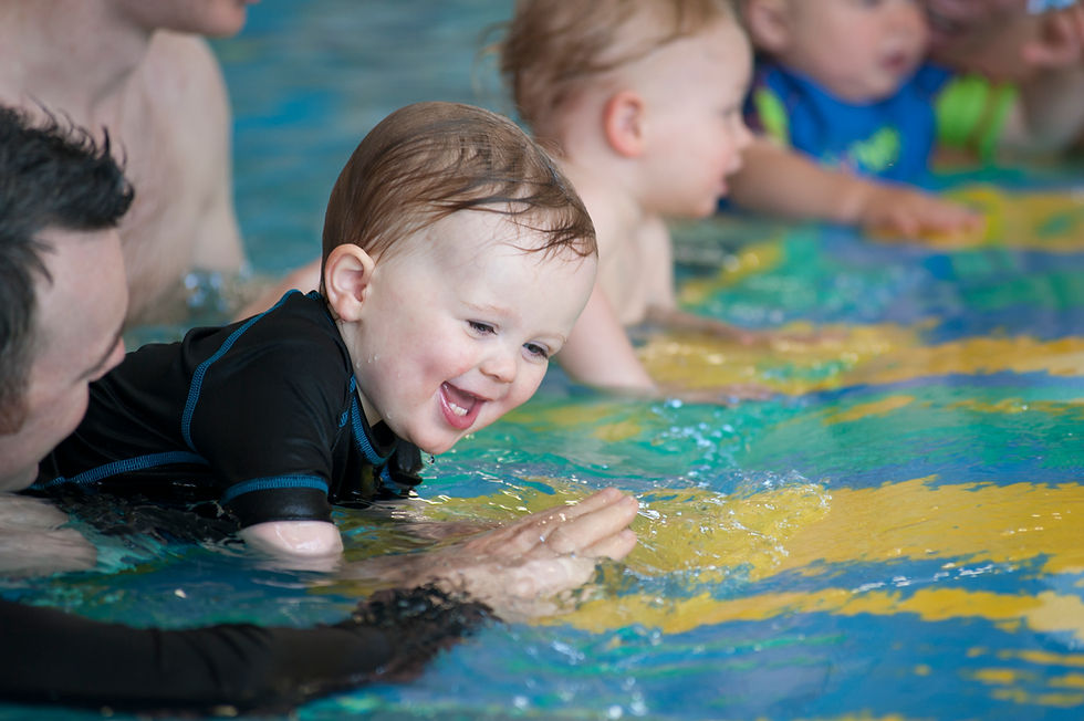 Baby swimming lesson with parent in pool