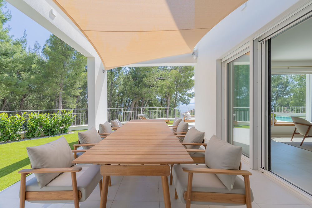 Villa C outdoor dining patio with wooden table & chairs