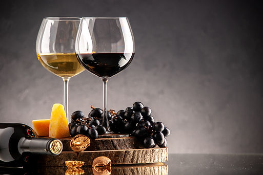 front-view-wine-glasses-fresh-grapes-walnuts-yellow-cheese-wood-board-overturned-bottle-da