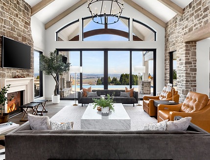 Beautiful living room in new traditional  luxury home. Features stone accents, vaulted cei