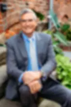 Jeff in suit, professional portrait of Heck & Stiffler background.