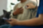 Healthcare worker using a stethoscope to examine a patient