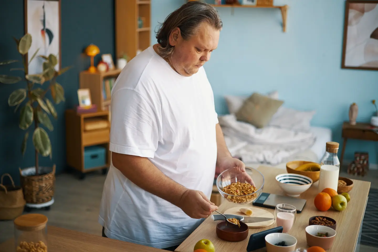 Overweight man preparing healthy breakfast cereal