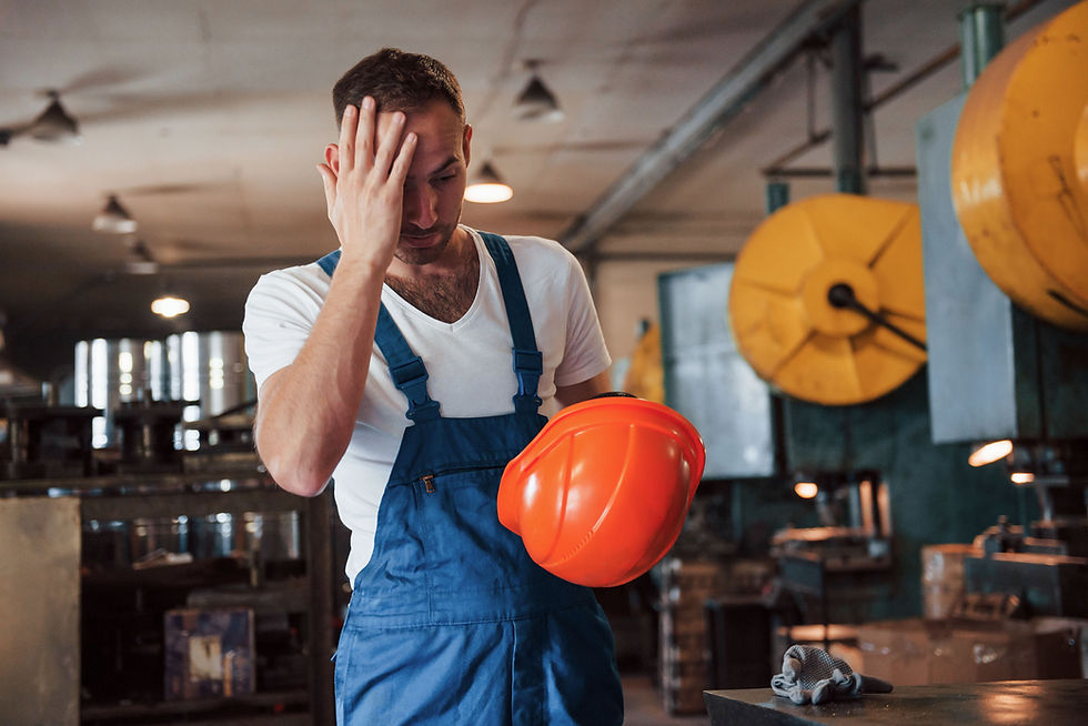 Construction worker holding his head