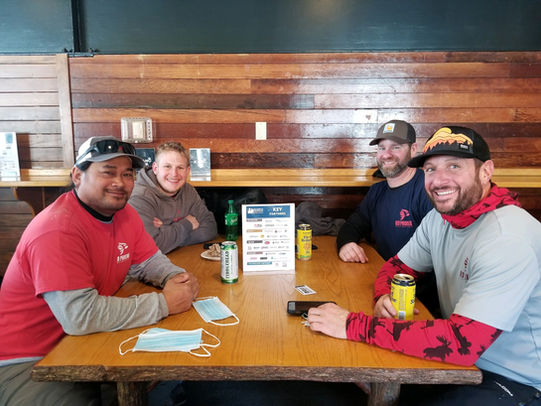 Four people sitting at a table smiling