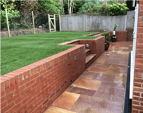 Expert brick retaining wall installation with landscaping stairs on a residential property in Richmond
