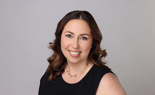 Dr. Whittemore—founder of Kinnect Psychology—smiling warmly in a professional headshot against a light‑gray backdrop.