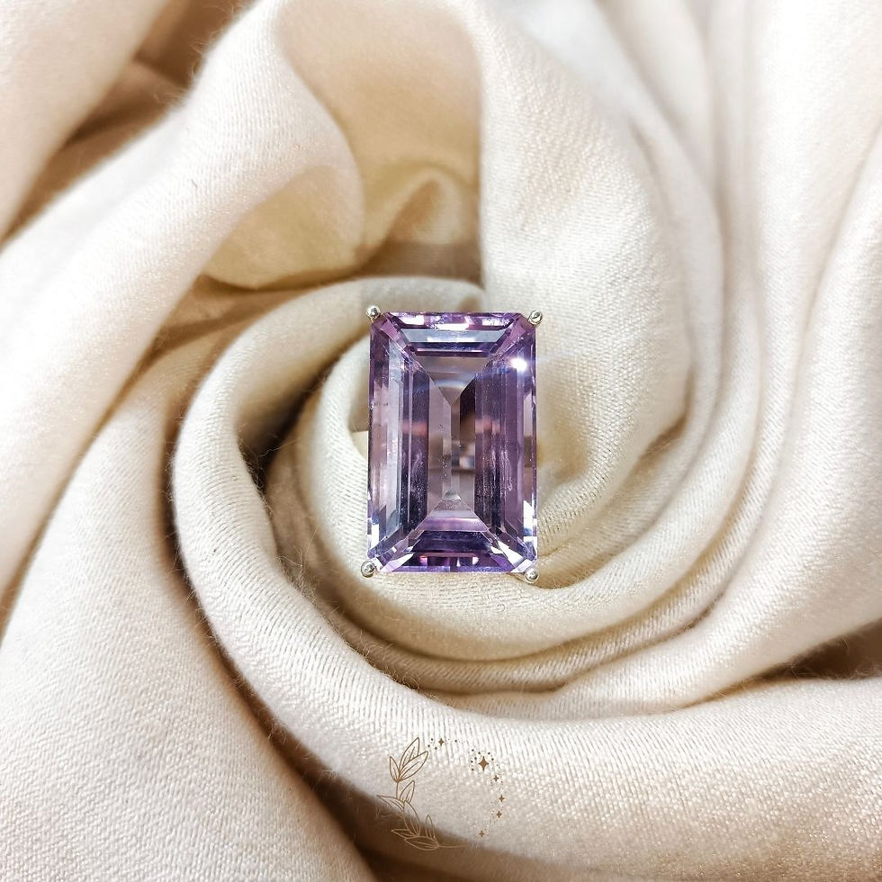 Handmade gemstone jewelry featuring a genuine amethyst centerpiece and adjustable sterling silver band.