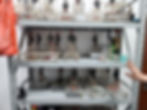 Shelves with clear acrylic electronic devices on test jigs.