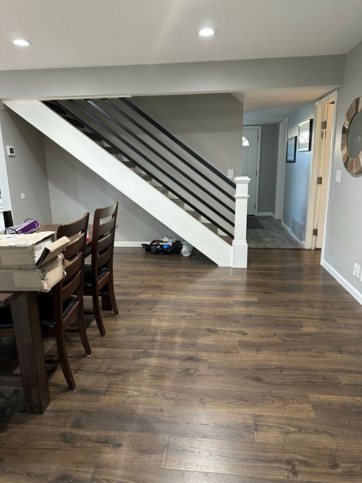 Modern open-concept living area featuring luxury dark wood flooring and custom staircase in Benicia.